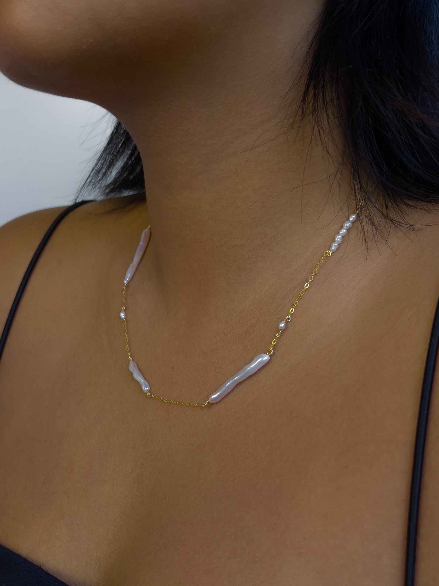 Biwa pearl gold necklace. This ultra fine 14 karat Gold filled with sterling silver flat cable chain suspends gorgeous Biwa elongated freshwater pearls and freshwater seed pearls. Designed and made by nāmaka.