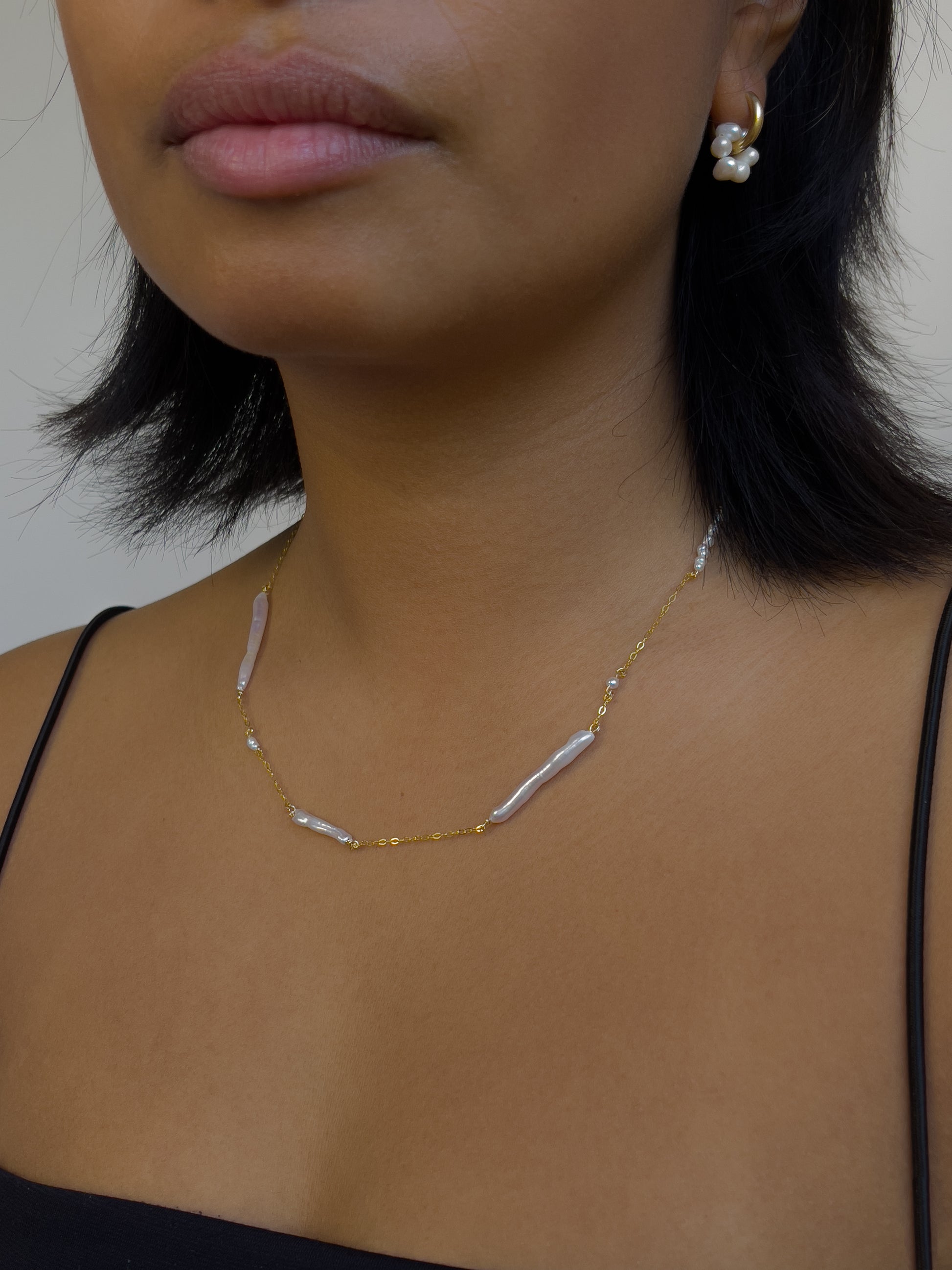 Biwa pearl gold necklace. This ultra fine 14 karat Gold filled with sterling silver flat cable chain suspends gorgeous Biwa elongated freshwater pearls and freshwater seed pearls. Designed and made by nāmaka.
