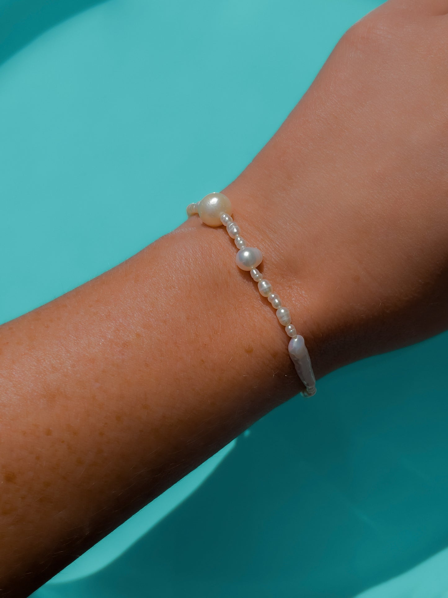 Biwa Pearl Bracelet. Natural elongated Biwa pearls placed off centre with a bold spherical Freshwater pearls. Using natural AAA quality freshwater pearls, in a minimal asymmetrical design. 14 Karat Gold filled Sterling Silver hardware finishes the piece.