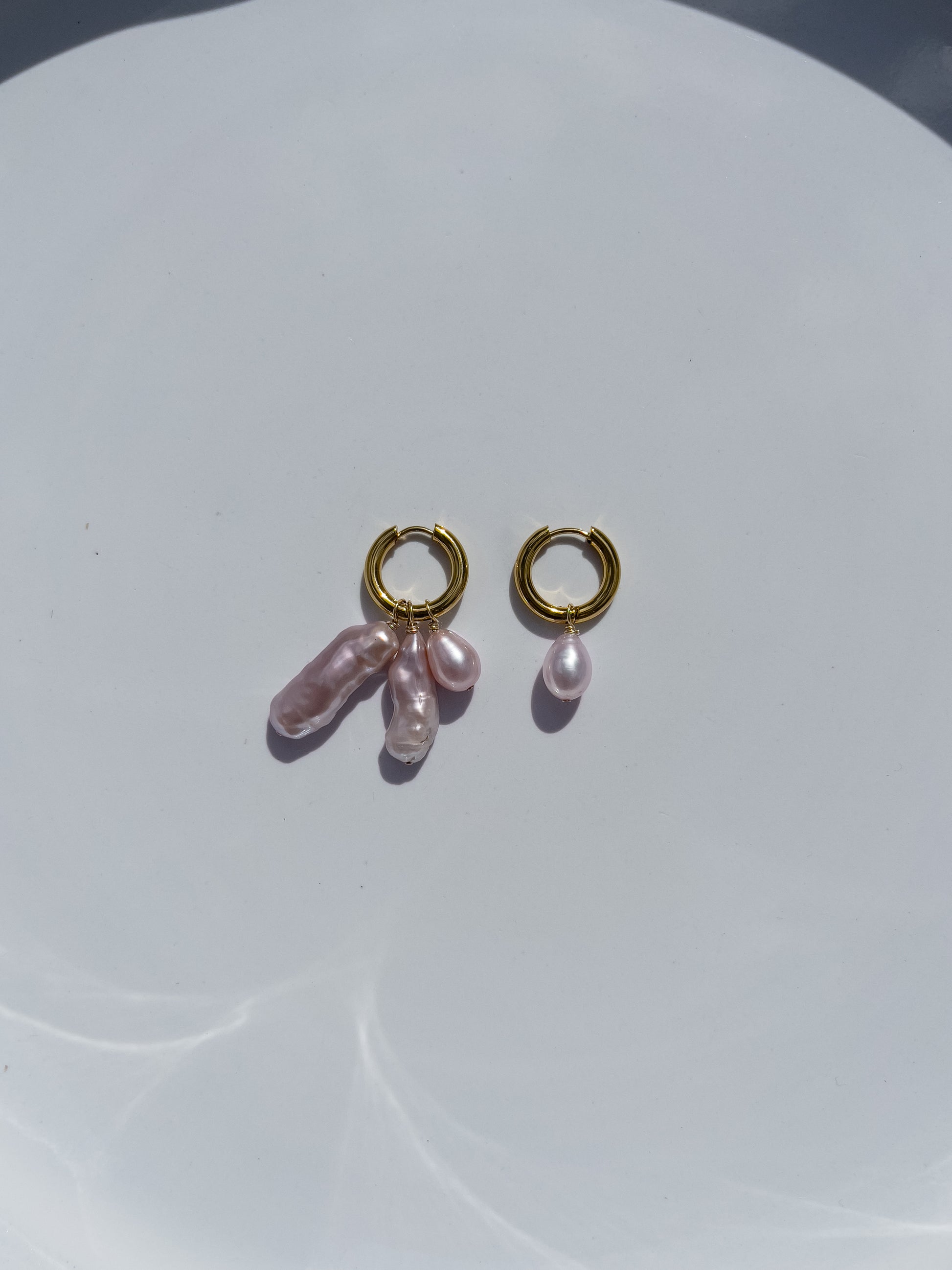 Violet Keshi Pearl Hoop Earrings. Chunky 18 karat Gold filled hoops, suspends both Violet Keshi, and Violet Teardrop pearls, and are AA quality.  In this minimal design, the free formed Keshi pearls, against the ultra smooth teardrop pearls are strikingly unique.