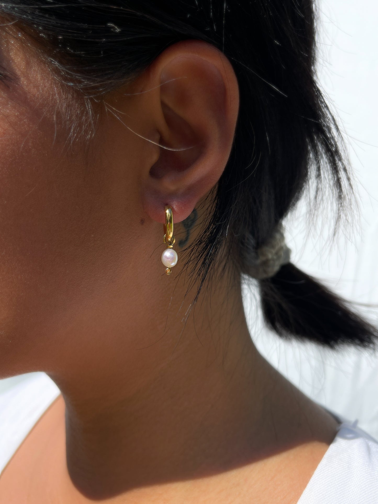 Biwa Pearl Gold Hoops. Chunky 18 karat Gold filled hoops, suspends both elongated Biwa, and round, natural AAA quality freshwater pearls, in a minimal asymmetrical design. Designed and made by nāmaka